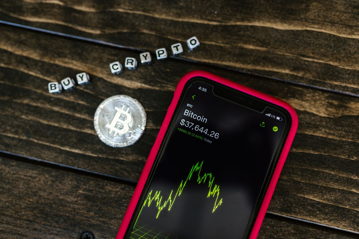 A phone showing a rising price chart, representing free coins adding up over time.